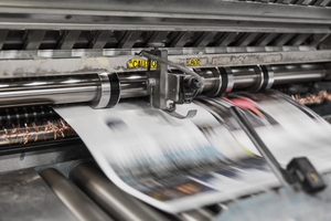 Eine Druckmaschine beim Drucken einer Journalseite.