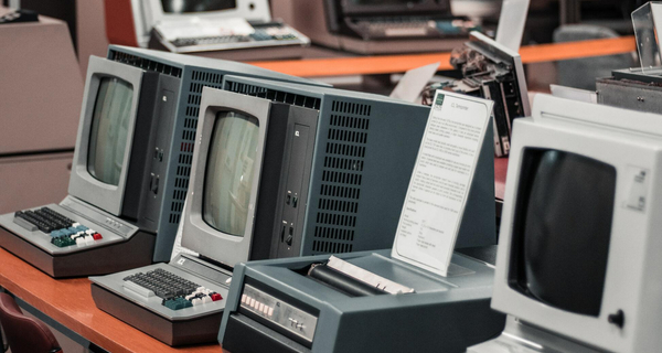 multiple historical computers standing on a table