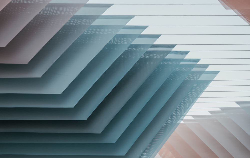 Abstract graphic of flat stacked rectangles with beige and blue shades.